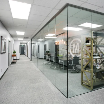 Office with commercial carpet and glass-walled meeting room.
